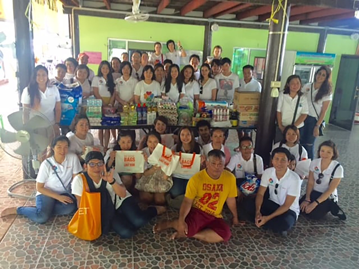 QNET staff outside at charity event