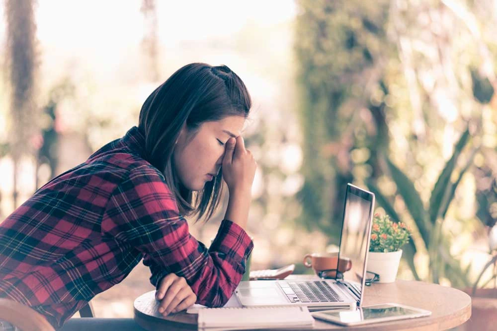 women in distress in front of her laptop