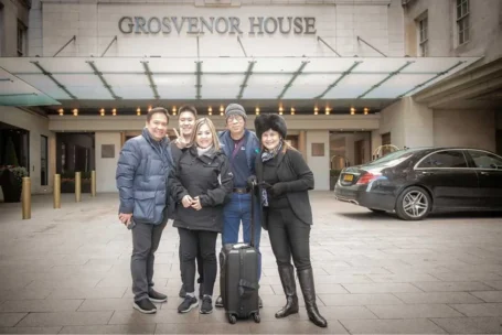 Hard Work Pays, Qnet’s Achievers Are The Proof! 2 QNET members standing in front of hotel