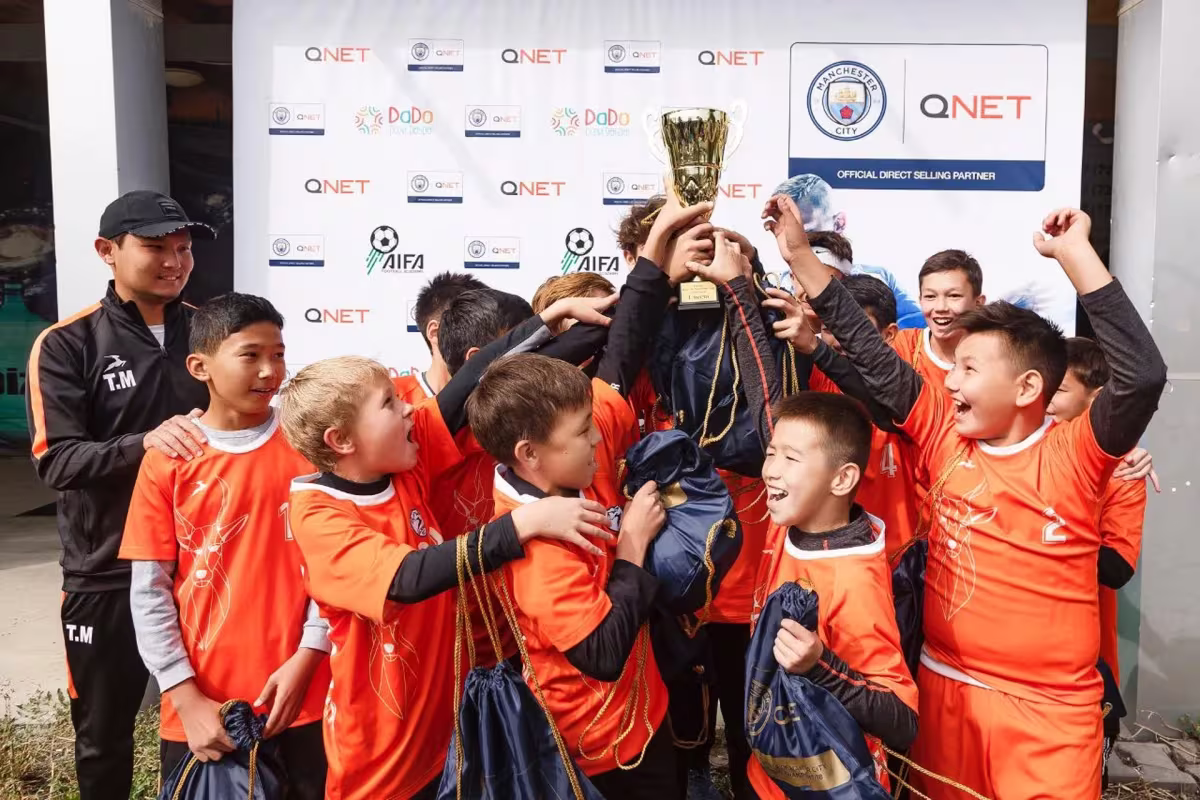 Qnet Football Tournament For Children A Grand Success 3 Children celebrating with golden trophy