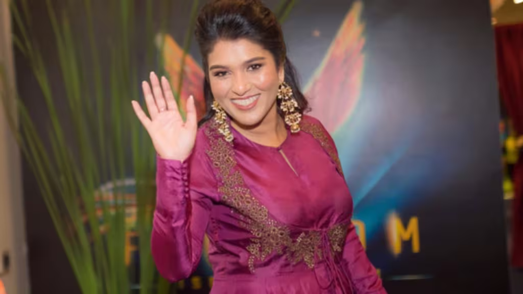 Sharfun Shaikh waving her hand smilling