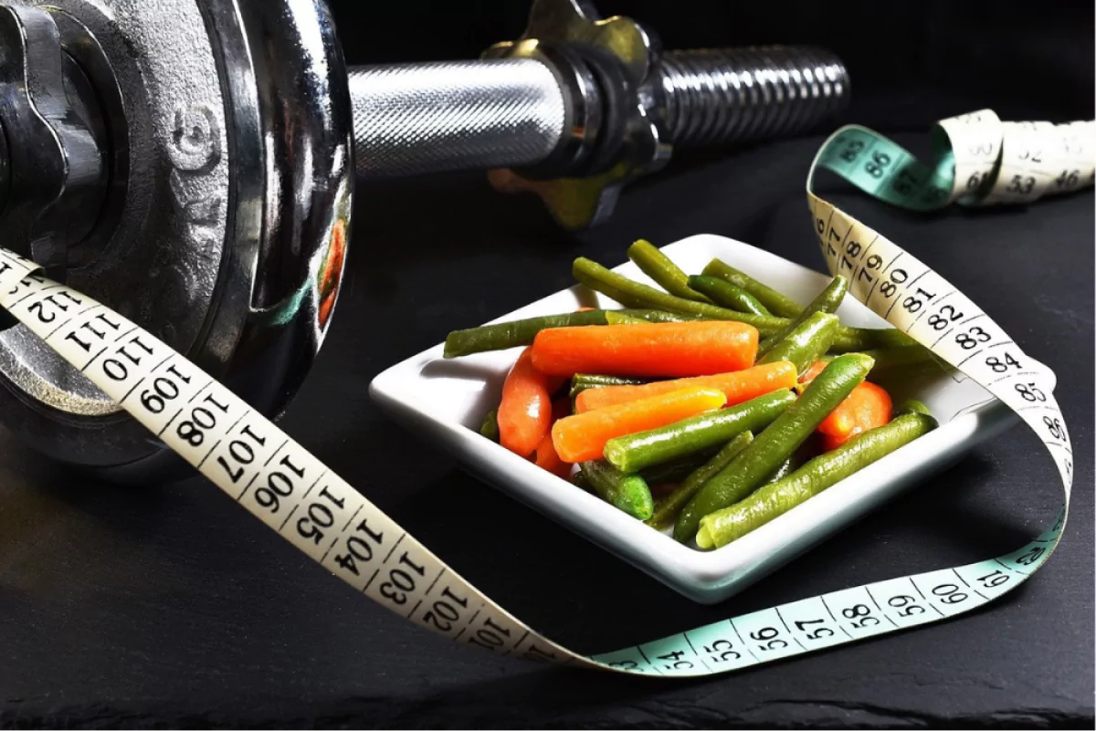 Plate of vegetables next to weights