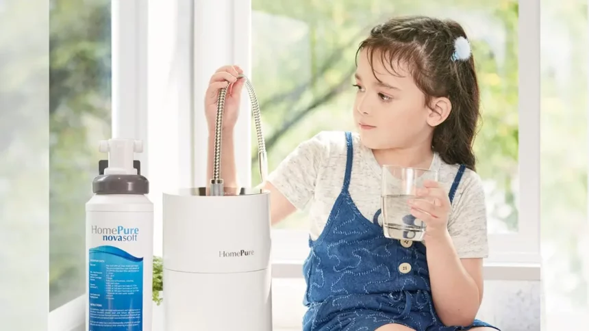 A girl seated, hydrating with HomePure, while reaching for the adjacent HomePure-NovaSoft-Solution-To-Hard-Water