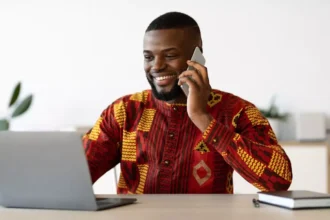 Man on phone smiling on QNET business call