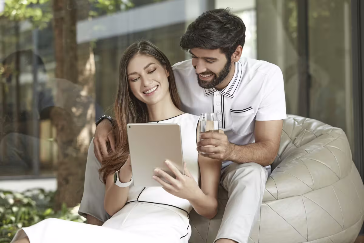 Modern-Day Alchemy: Using Science To Get More Out Of Your Water Smiling couple sitting in living room couch holding HomePure Viva glass