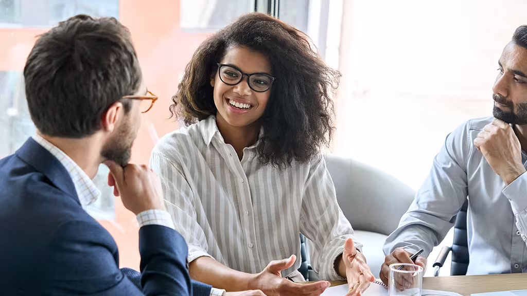 Shattering Glass Ceilings: Why Women In Leadership Matter 2 People in a meeting room brainstorming good ideas
