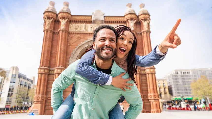 Man giving woman a piggy back ride in Europe while on a trip booked through a QVI holiday membership