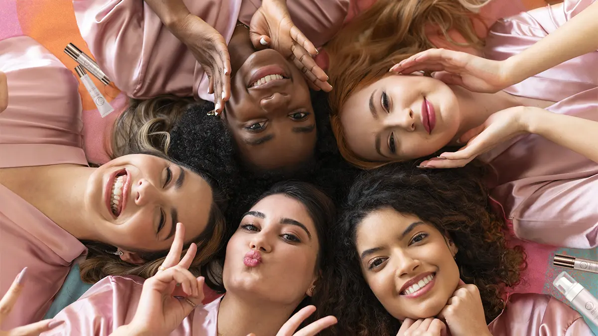 Women lying down surrounded by Physio Radiance products, some of the popular QNET gifts for women.