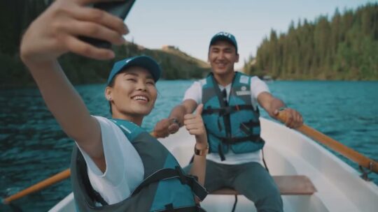 Here Are All The Reasons Why People Join Qnet 3 Couple wearing QVI hats on a boat in the lake smiling