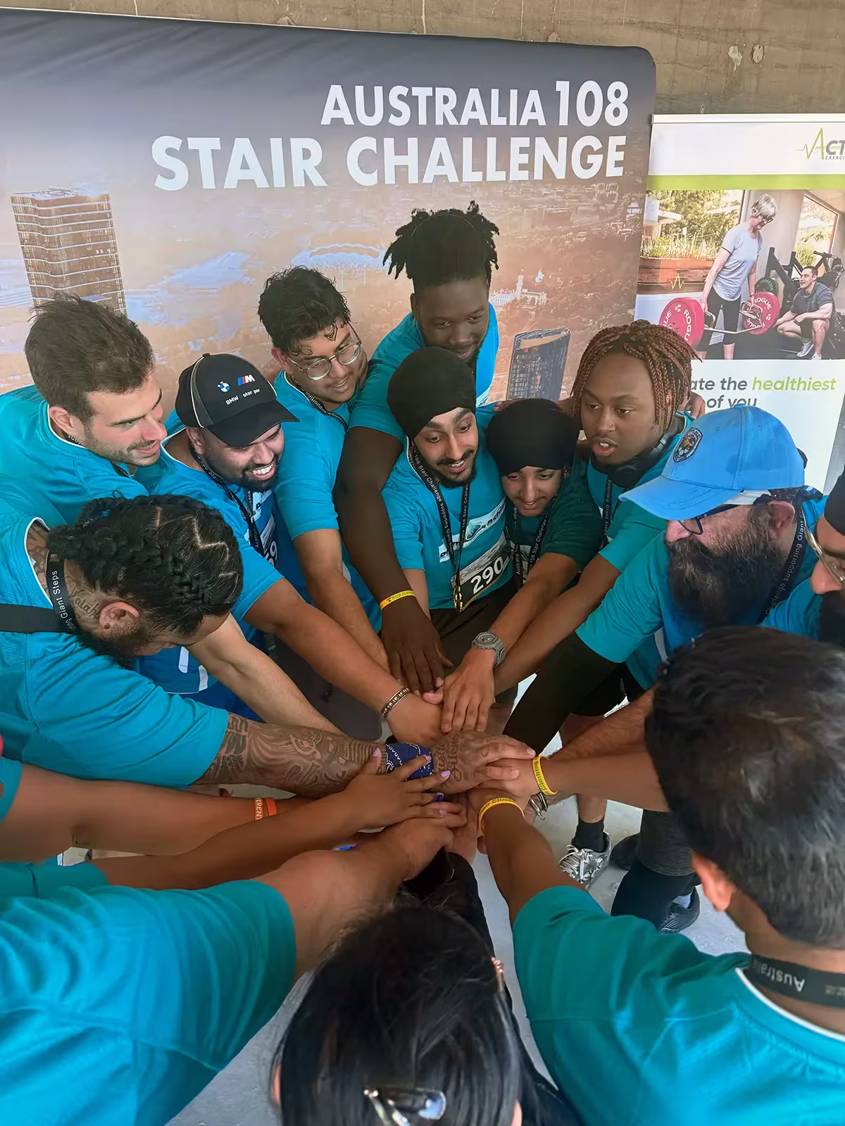 Journey To The Top: Avp Perminderjit Singh Scales New Heights At 2024 Australia 108 Stair Challenge 3 AVP Perminderjit Singh's DreamAchiever Team join hands in a huddle before they climb Australia 108