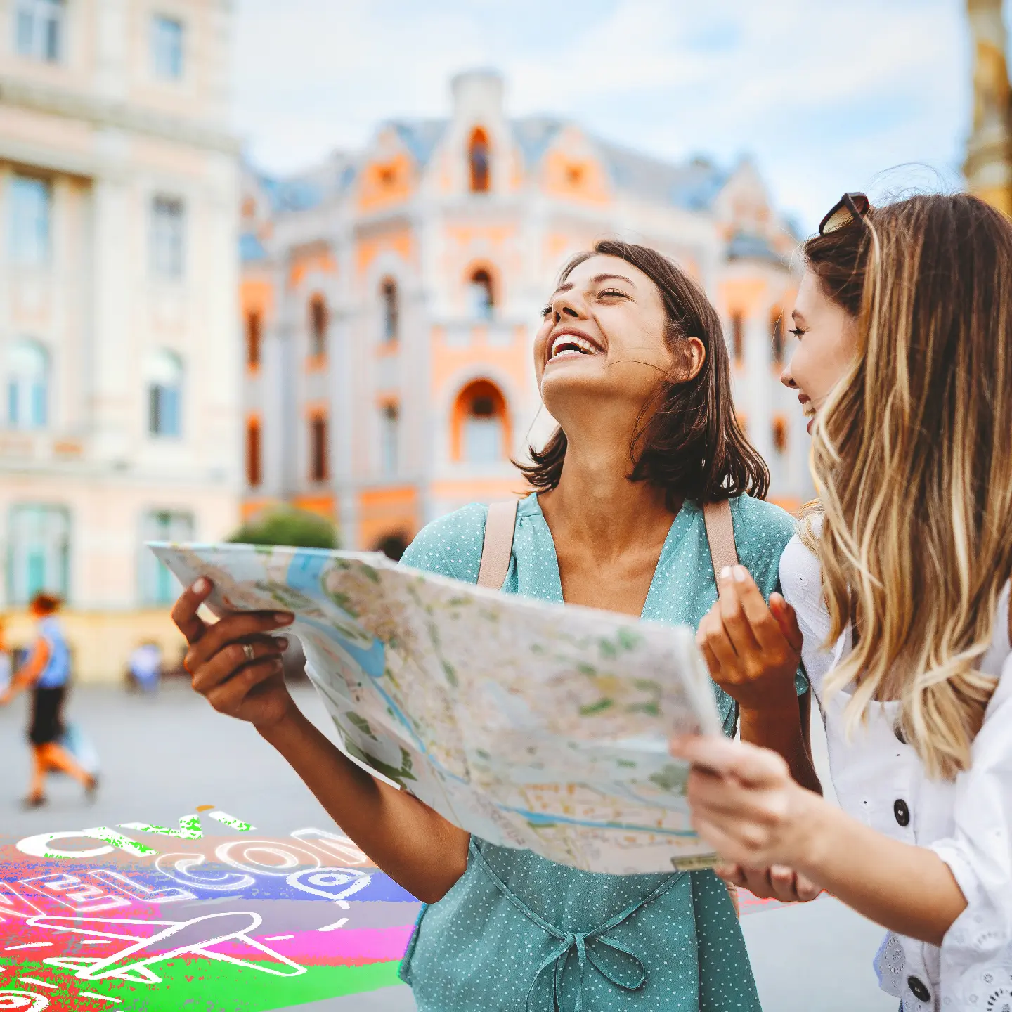 two friends hold a map as they enjoy their QVI package holiday experience in a European city 