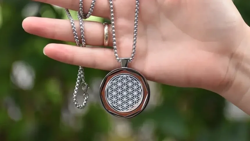 Gift Guide For Him: Gift Ideas For The Men In Your Life This Father'S Day 4 A hand of a person hold a Amezcua Chi Pendant 4. One of the QNET wellness product which would be one of the gift idea.