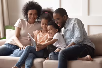 Family sitting on couch smiling