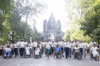 Participants in the march for a mine-free Cambodia sponsored by QNET, in front of Angkor Wat