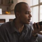 Man recording a voice message and wondering is the middle class the new poor