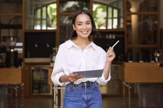 What is Micro-Entrepreneurship? Woman holds up a tablet and pen in front of a nice venue