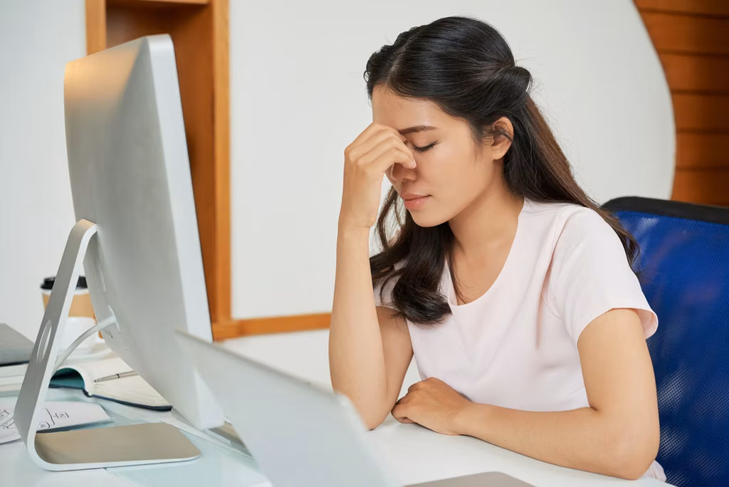 Don’t Let Your Home Become A House Of Horrors 3 A girl experiencing eye strain while using an electronic device, highlighting the Amezcua E-Guard X.